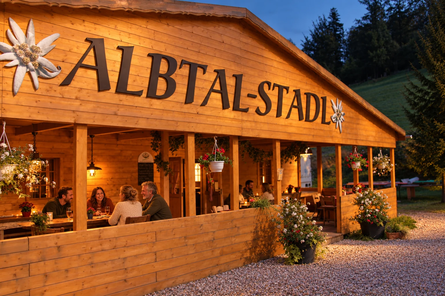 Beleuchtete Holzfassade des Albtal-Stadl am Abend.